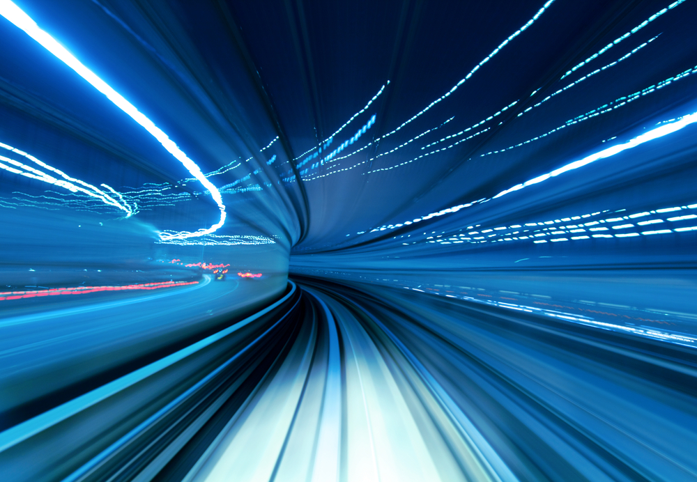 Train moving fast in tunnel with light bending