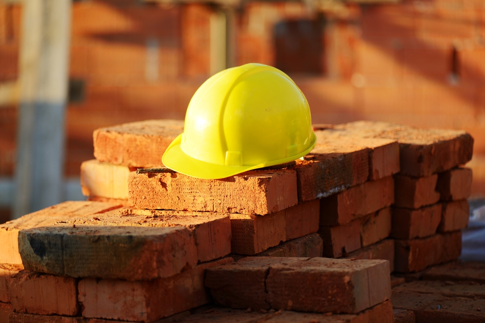 construction helmet and bricks at building site