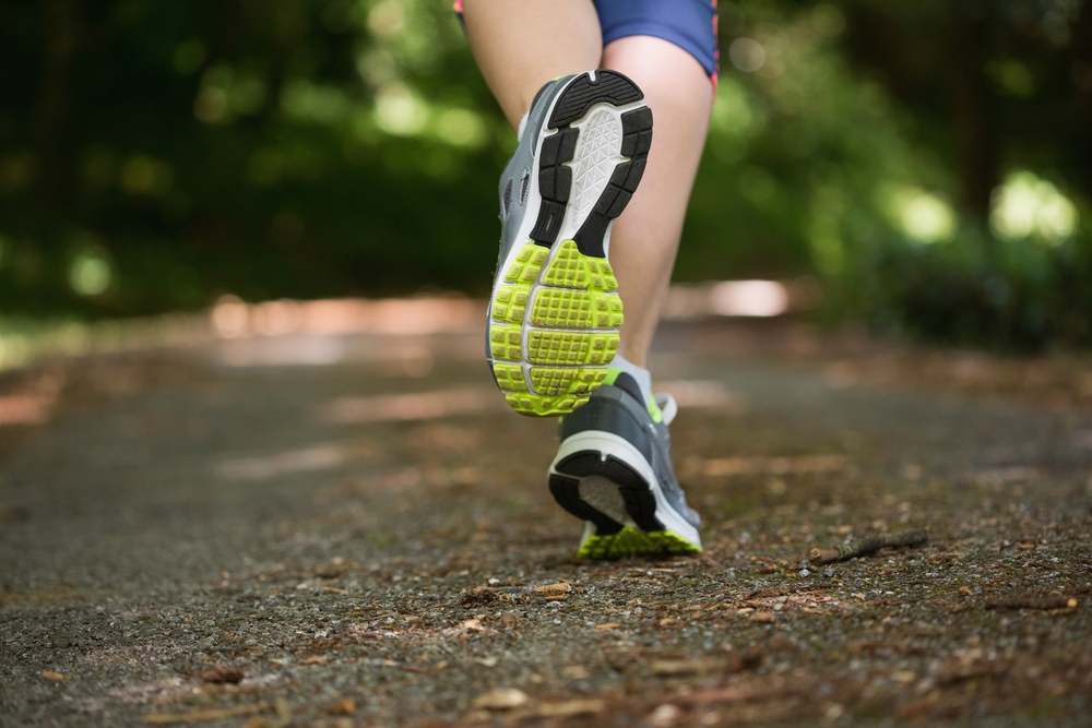 Close up of the sneakers of a person jogging away from camera