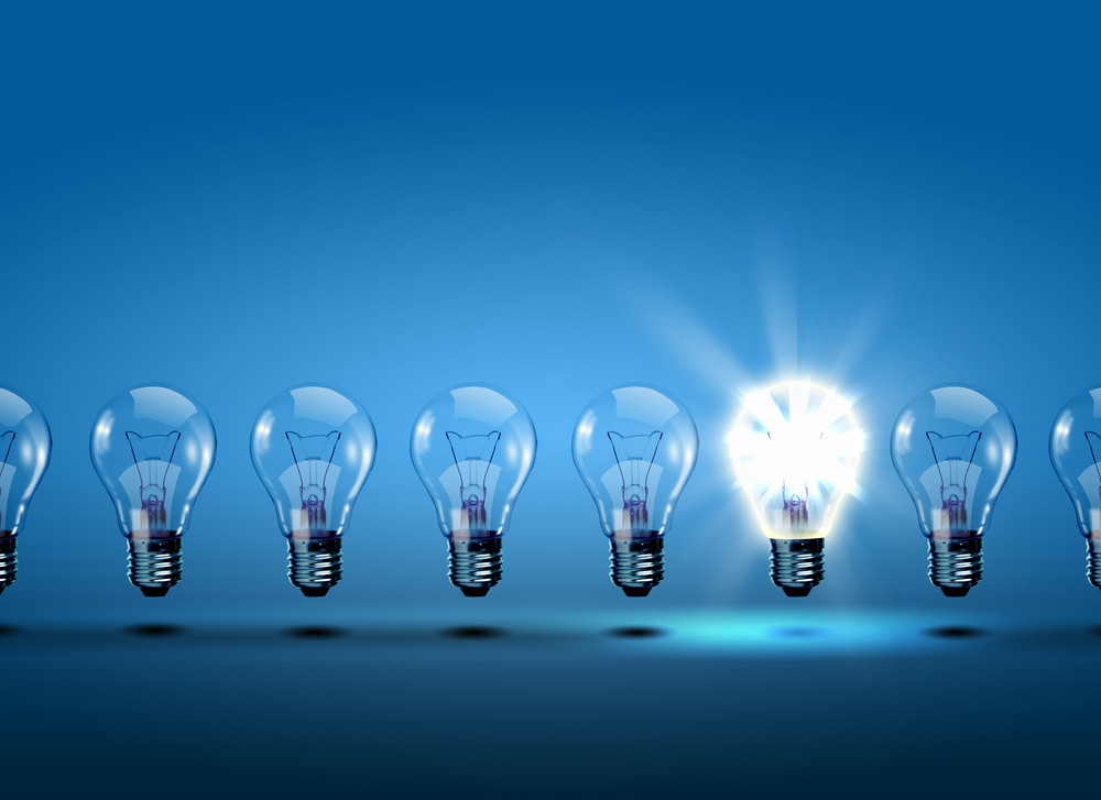 row of light bulbs with one illuminated